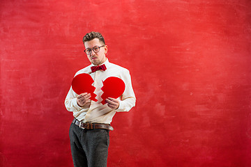 Image showing Young funny man with abstract broken heart