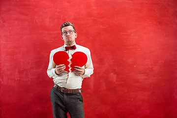 Image showing Young funny man with abstract broken heart