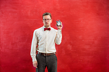 Image showing Young funny man with abstract clock