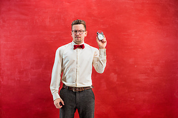 Image showing Young funny man with abstract clock