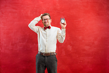 Image showing Young funny man with abstract clock