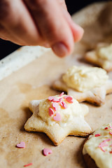 Image showing Person decorating cookies