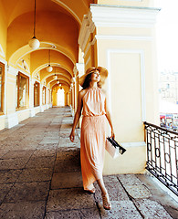 Image showing young pretty smiling woman in hat with bags on shopping at store