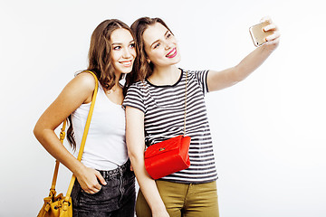 Image showing two best friends teenage girls together having fun, posing emotional on white background, besties happy smiling, making selfie, lifestyle people concept