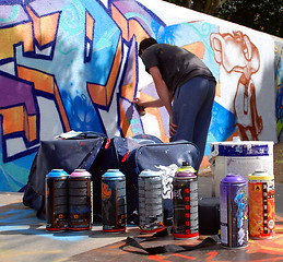 Image showing Graffiti artist at work with tools