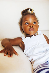 Image showing little pretty african american girl sitting in white chair weari