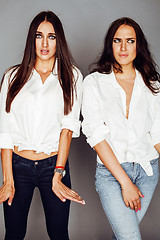 Image showing two sisters twins posing, making photo selfie, dressed same whit