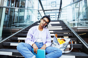 Image showing young cute modern indian girl at university building sitting on 