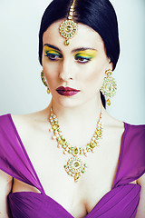 Image showing young pretty caucasian woman like indian in ethnic jewelry close up on white, bridal makeup