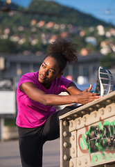 Image showing African American woman doing warming up and stretching