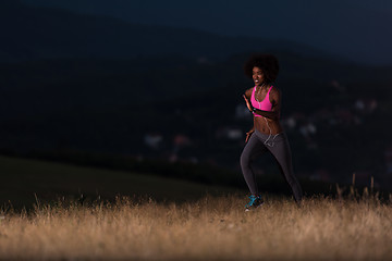 Image showing Young African american woman jogging in nature