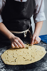 Image showing Cook cut out dough for cookies