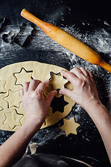 Image showing Cook making star-shaped cookies with form