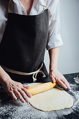 Image showing Person rolling homemade cookie dough