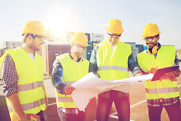 Image showing group of builders with tablet pc and blueprint