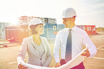 Image showing happy architects with blueprint at building