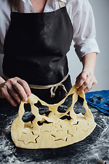 Image showing Cook cut out dough for cookies