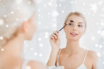 Image showing woman brushing eyebrow with brush at bathroom