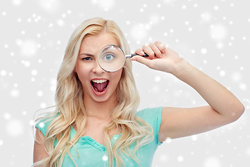 Image showing happy young woman with magnifying glass