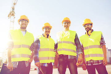 Image showing group of smiling builders with tablet pc outdoors