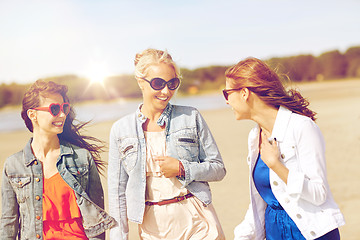 Image showing group of smiling women in sunglasses on beach