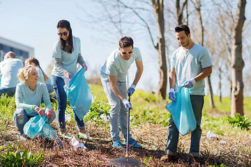 Image showing volunteers with garbage bags cleaning park area