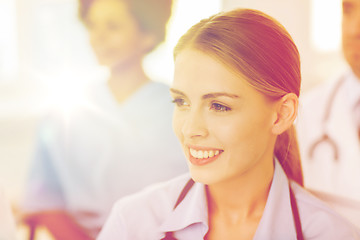 Image showing happy doctor over group of medics at hospital