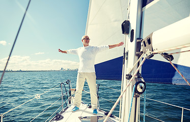 Image showing senior man on sail boat or yacht sailing in sea