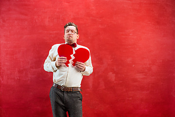 Image showing Young funny man with abstract broken heart