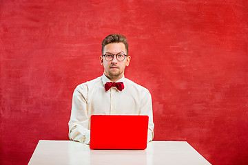 Image showing Young funny man with laptop at St. Valentine\'s Day