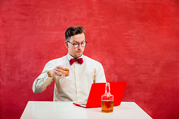 Image showing Young funny man with laptop at St. Valentine\'s Day