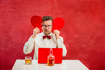 Image showing Young funny man with abstract broken heart