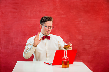 Image showing Young funny man with laptop at St. Valentine\'s Day