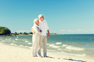 Image showing happy senior couple hugging on summer beach