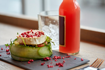 Image showing salad, bottle of drink and glass on cafe table