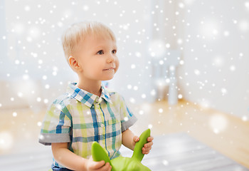 Image showing happy baby boy playing with ride-on toy at home