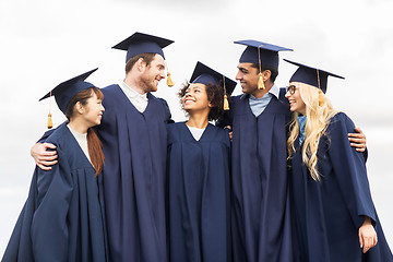 Image showing happy students or bachelors in mortar boards