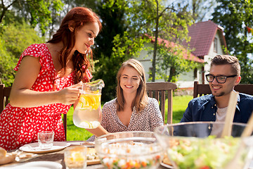 Image showing happy friends having dinner at summer garden party