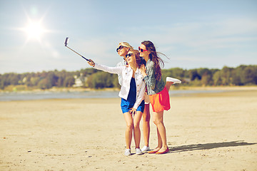 Image showing group of smiling women taking selfie on beach