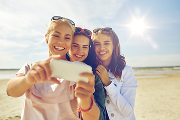 Image showing group of smiling women taking selfie on beach