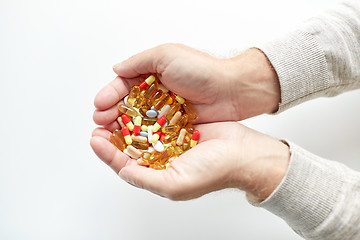 Image showing close up of old man hands holding medicine