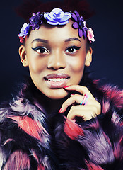 Image showing young pretty african american woman in spotted fur coat and flowers jewelry on head smiling sweet etnic girl