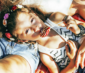 Image showing cute happy family on picnic laying on green grass mother and daughter, warm summer vacations close up