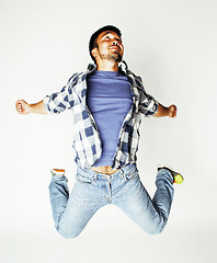 Image showing young pretty asian man jumping cheerful against white background, lifestyle people concept