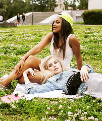 Image showing two pretty girls on grass happy smiling, best friends having fun together, lifestyle people concept