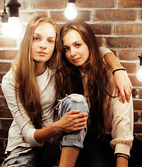 Image showing pretty teenage girlfriends having fun in stylish modern loft studio, lifestyle people concept