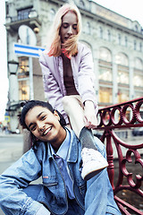 Image showing cute young couple of teenagers girlfriends having fun, traveling europe, modern fashion citylife, lifestyle people concept