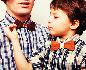 Image showing father with son in bowties on white background, casual look