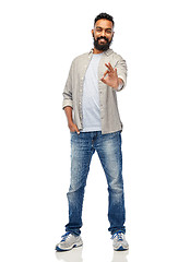 Image showing happy smiling indian man showing ok hand sign