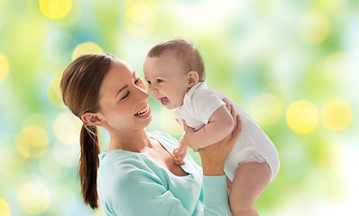 Image showing happy mother with little baby over green lights